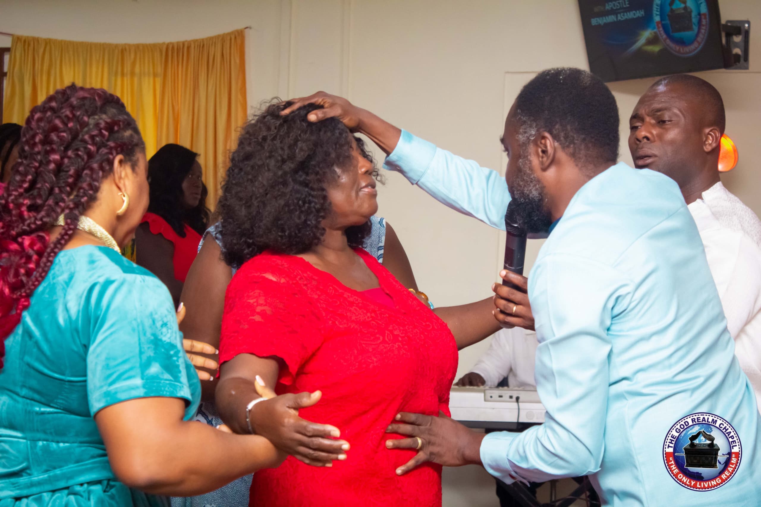 Apostle Benjamin Asamoah praying for a congregant