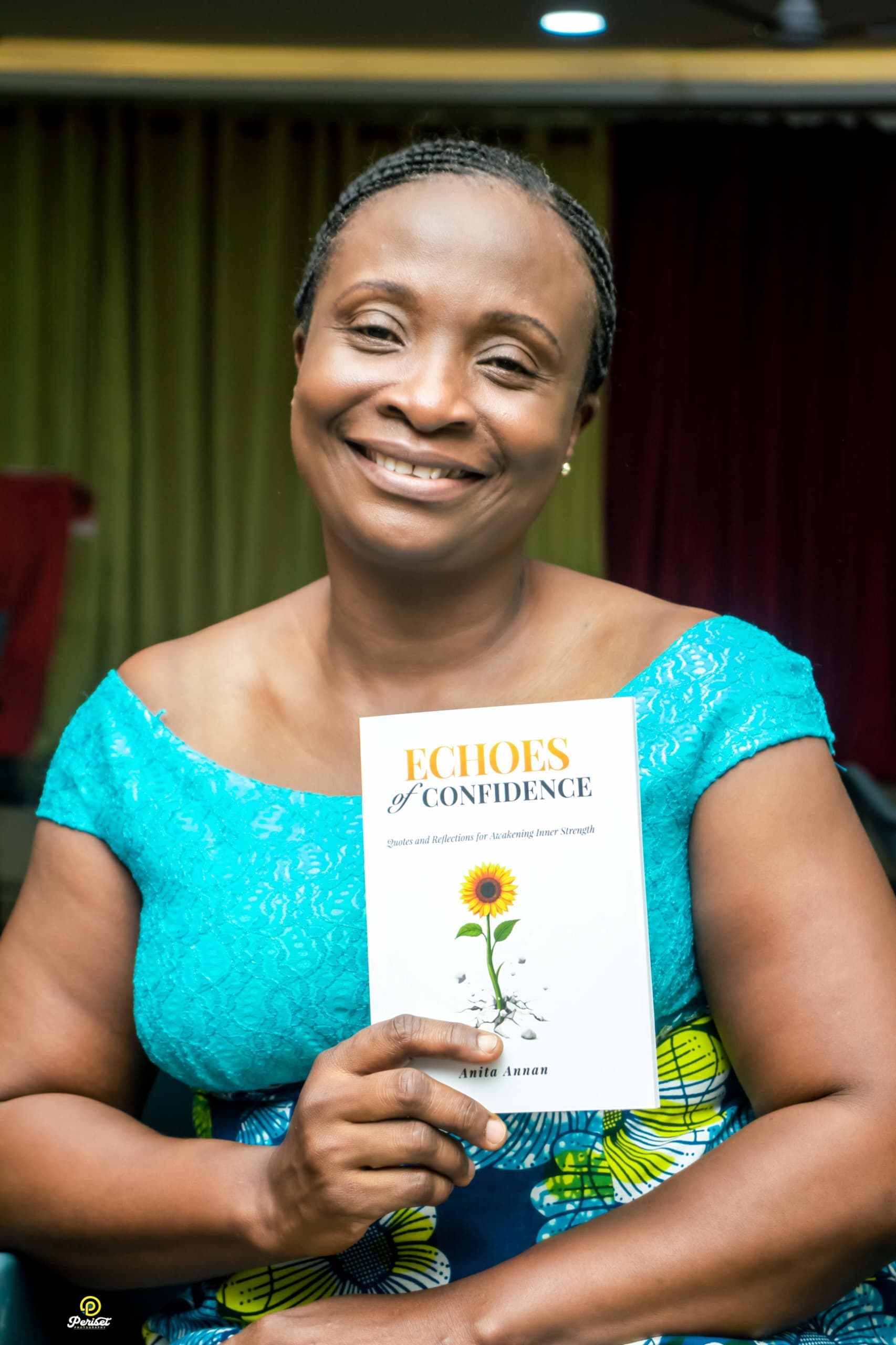Anita Annan holding Echoes of Confidence at a book event